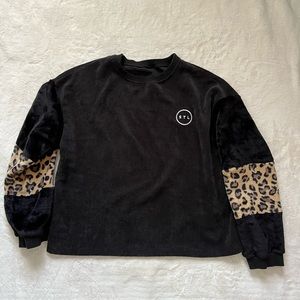 Black corduroy crew neck with STL city circle logo